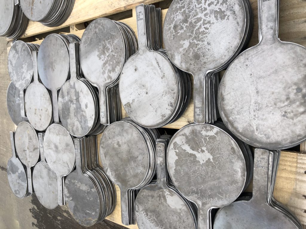 many skillet blinds arranged on a wooden pallet